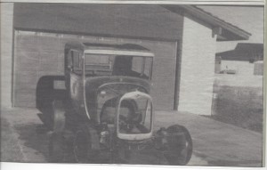 An old photo from a newspaper of an old car 