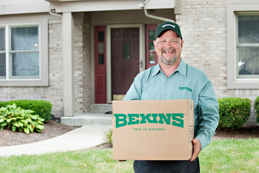 Bekins employee holding a box.