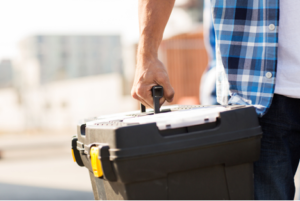Person carrying toolbox.