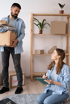 Moving checklist on clipboard with cardboard boxes in the background