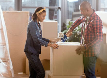 family packing moving boxes