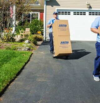 Professional movers helping someone move out of their home.