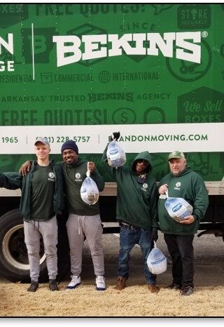 Bekin employees posing in front of Bekins van