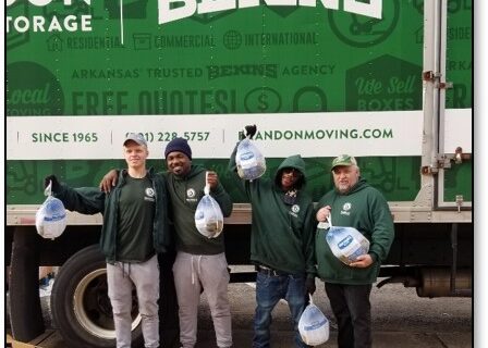 Bekin employees posing in front of Bekins van