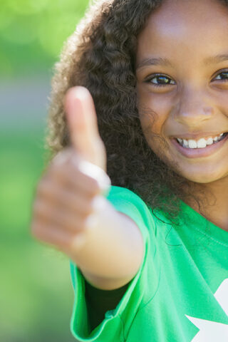 little girl giving a thumbs up