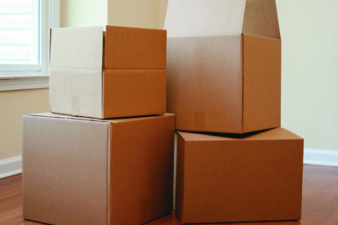 Packing boxes scattered in an empty room