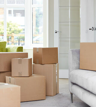 Stacks of boxes in a living room.