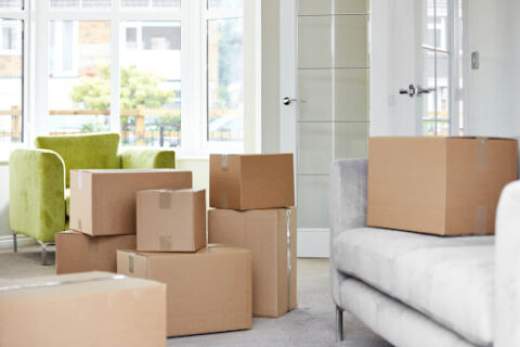 Stacks of boxes in a living room.