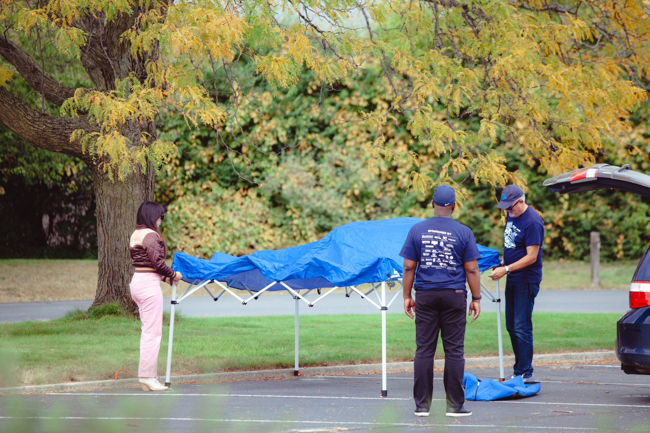 DJ and volunteers set up tent at truck pull fundraiser