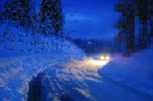 Car headlights in snowy night