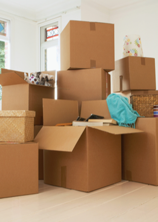 Cardboard boxes stacked in empty room