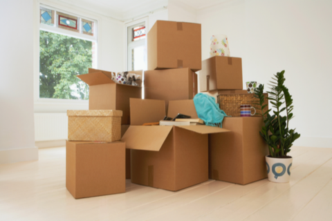 Cardboard boxes stacked in empty room