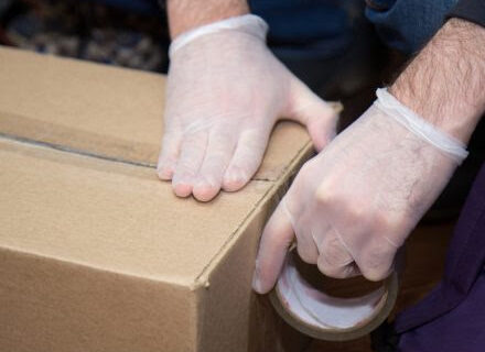 safely packing box with gloves