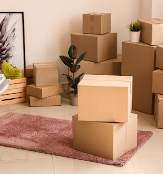 Stacks of moving boxes with fragile items on top.