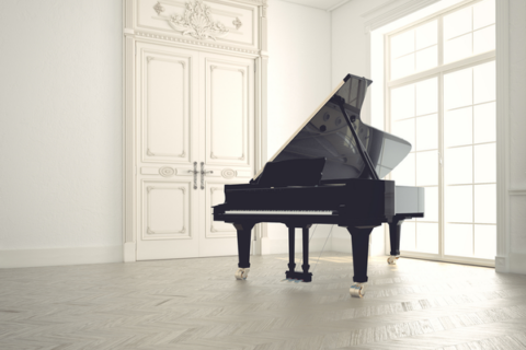 Grand piano in a fancy, clean white room
