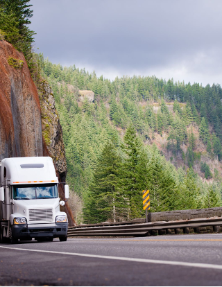 Moving truck driving on winding mountain road