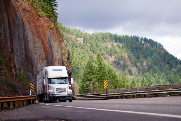 Moving truck driving on winding mountain road