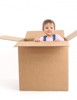 infant inside a packing box