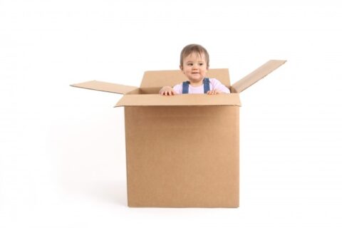 infant inside a packing box
