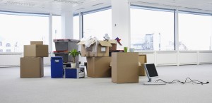 Boxes of office items in empty office space.