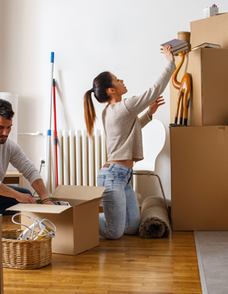 Young couple packing cardboard boxes