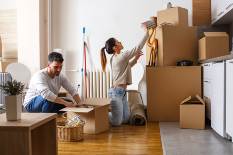 Young couple packing cardboard boxes