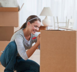 woman writing on a packing box