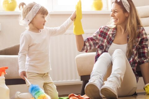 A child and an adult high-fiving after cleaning.