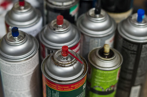 Closeup of spray paint canisters.