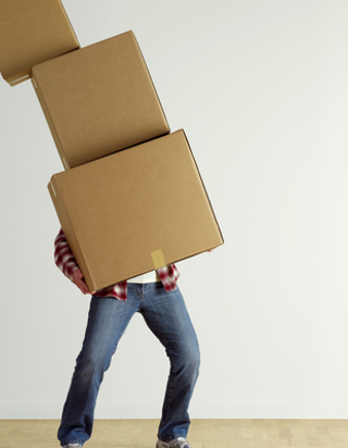 man holding a falling stack of boxes