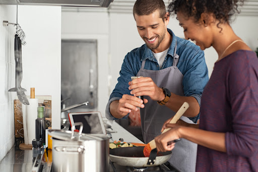 A couple cooking in their kitchen.