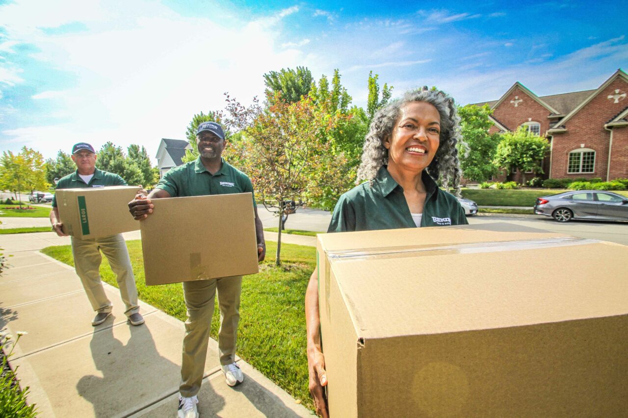 Bekins movers carrying boxes.