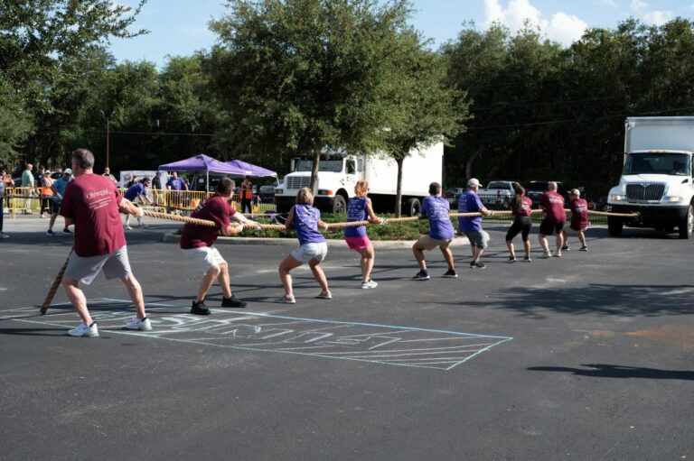 A team pulling a moving truck with a rope at Bekins' latest GKTW fundraiser, the 2023 Truck Pull in Kissimmee, Florida