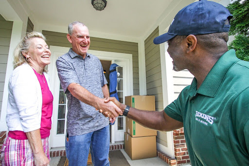 Bekins mover shakes hand of older adult customer.