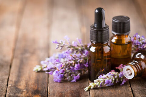 Small essential oil bottles surrounded by lavender buds.