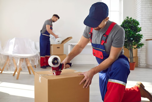 Movers taping boxes.