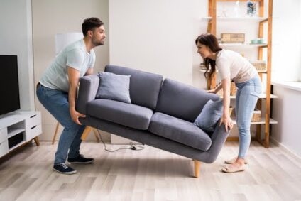 Couple moving a couch