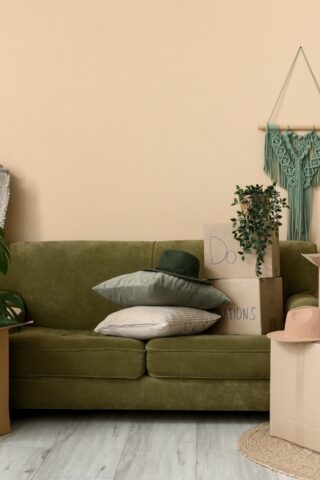 A living room with moving boxes and a large mirror.