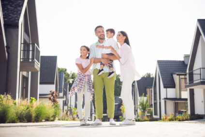 A young family walks through a new neighborhood.